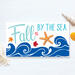 This whimsical autumn-themed coastal sign with bright blue waves, fall leaves, and an orange resin starfish for your coastal fall decor.
